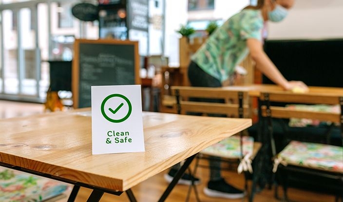 Clean and safe sign placed on table in restaurant